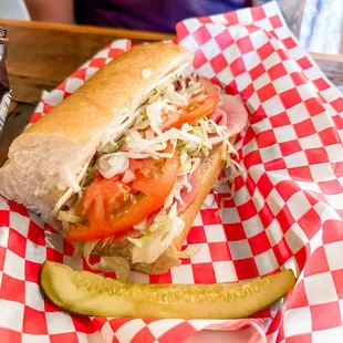 a sub sandwich and a pickle