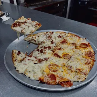 a slice of pizza being lifted by a spatula