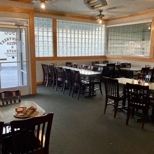The entrance of the restaurant with many wooden tables