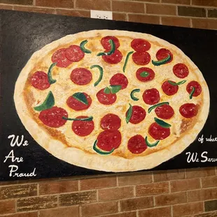 A pizza painting saying &quot;we are proud of what we serve&quot;