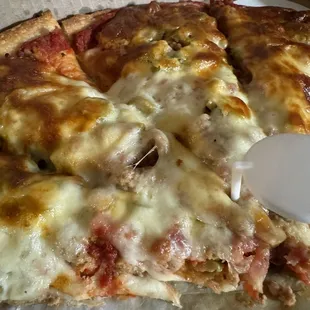 Hamburger, bacon , and green olives.