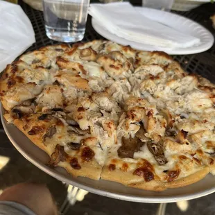 a whole pizza on a plate
