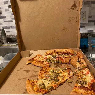 a half eaten pizza in a box