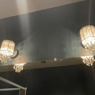 Attention to detail.. Beautiful chandelier lights in the restroom.