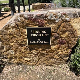 a large rock with a sign on it