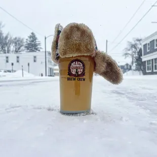 a teddy bear in a pint of beer