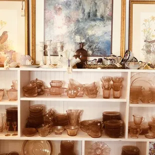 Wall of color coordinated pink dishes!