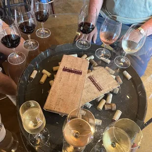 a table with wine glasses and a menu