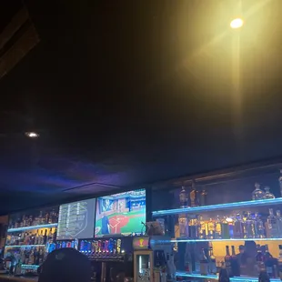 a bar with a lot of bottles on the shelves
