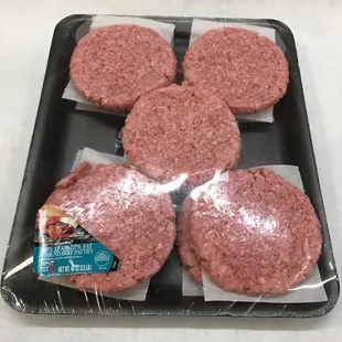 a tray of ground beef patties