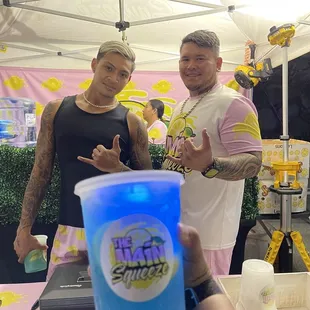 a man holding up a blue cup