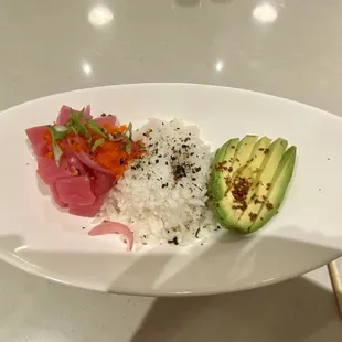 a plate of sushi and avocado