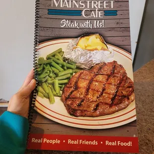 a person holding a menu book