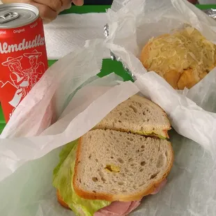 ? sandwich (we ordered corned beef but this certainly is not it...) and knackswurst roll. Almdudler is a soda from Austria.