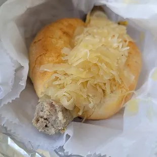 a half eaten sausage sandwich