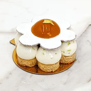 Financier Biscuit, Light Lime Whipped Cheese Cake a touch of vanilla. Sable biscuit with light powdered sugar, topped with Mango gelee.