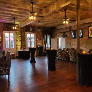 a large room with a piano and tables