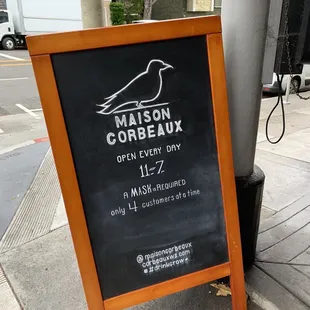a blackboard sign on a sidewalk