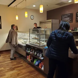a group of people in a bakery