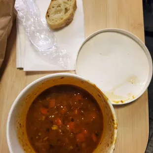 a bowl of soup and a plate of bread
