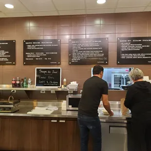 a man and a woman standing in front of a counter