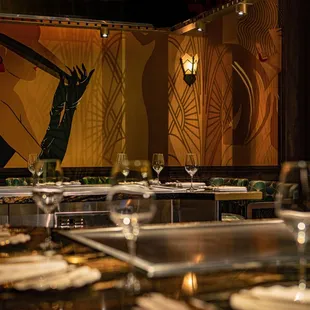 a dining room with a large painting on the wall