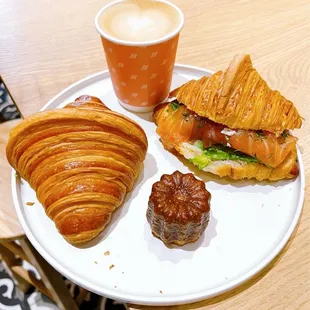 Croissant, salmon croissant sandwich, canele, oat milk cappuccino