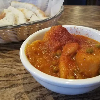 Potato and Green Pea Curry over Rice