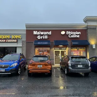 three cars parked in front of a restaurant