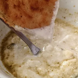 Flatbread dipped in yogurt mixed with chutney