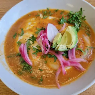 Huevos Rancheros (tortilla with spreadable beans, two eggs, smothered in a spicy ranchera sauce and topped with avocado).