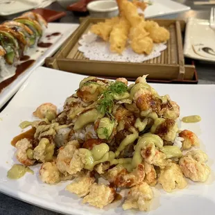 a variety of sushi and rolls on a white plate