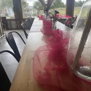 a long table with vases of flowers