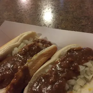 two chili dogs with onions