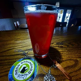 a pint of red wine and a necklace