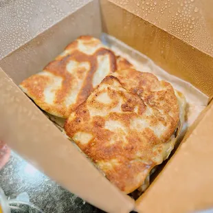 two pieces of pizza in a box