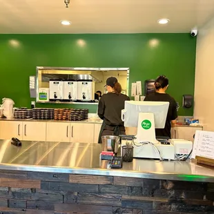 a man and a woman standing at a counter
