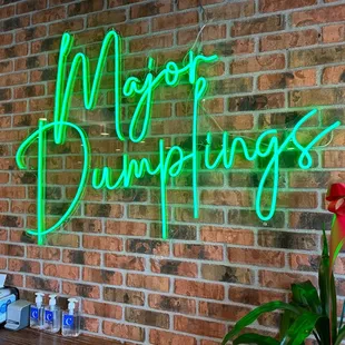 neon sign on brick wall