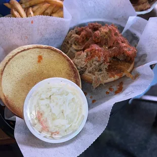 Pulled Cajun shredded pork sandwich and seasoned french fries.