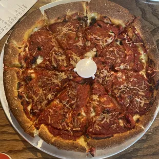 a pepperoni pizza on a pizza pan