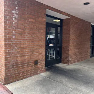 the entrance to a brick building