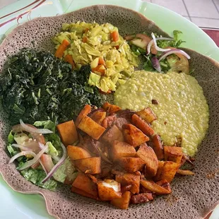 Full entree portions of Spicy Dinich Wot, Quosta, Tikil Gomen, and mild Misir Wot