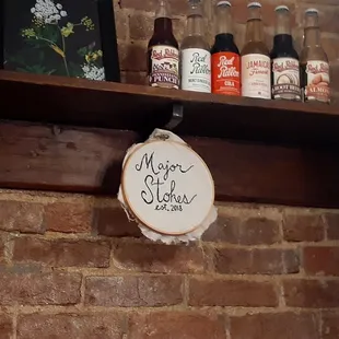 a sign on a brick wall