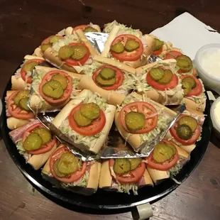 24 pieces Deluxe Hoagie Tray $36.99 with an assortment of ham, turkey, and Italian with raw onions, mayo, and hot peppers on the side.