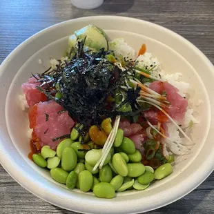 Spicy tuna, regular tuna, avocado, edamame, sprouts, nori, with spicy sauce and furikake, over white rice.