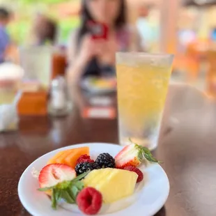 SLICED SEASONAL FRUIT AND BERRIES pineapple, cantaloupe, papaya, blackberries, raspberries, strawberry