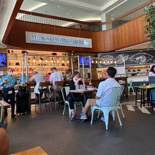 people sitting at tables in a restaurant