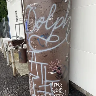 Dolph graffiti on the billboard post next to the bakery
