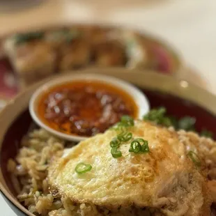 a bowl of rice with a fried egg on top