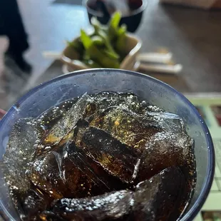 a bowl of cola with ice